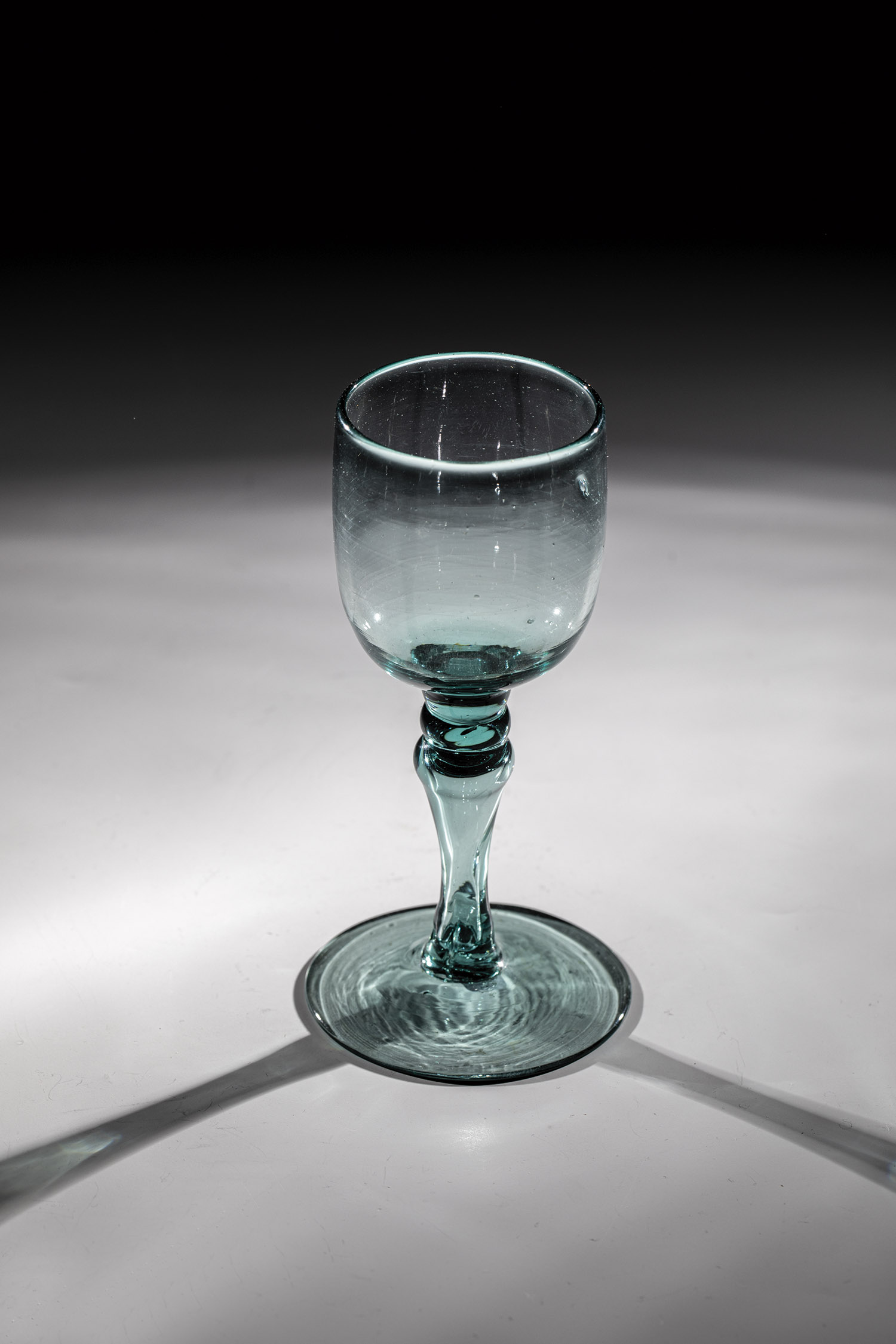 Roman Northern Germany, 19th century Blue-green glass. Disc foot with tear-off. Baluster shaft