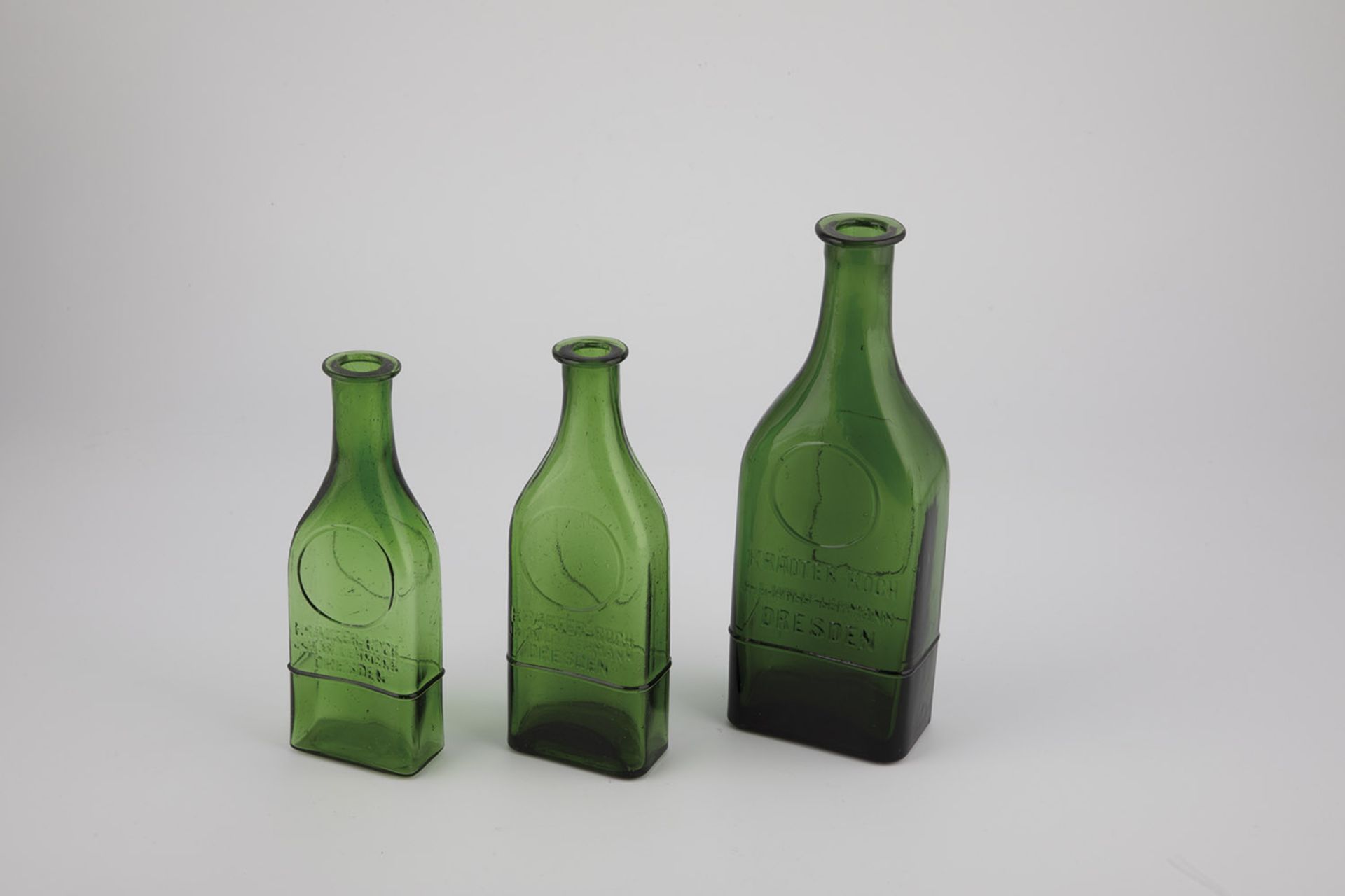 Three bottles of Germany, 20th century Green glass with embossed inscription: ''HERB SMELL INH.