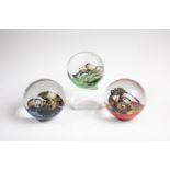 Three Paperweights 20th Century Three Glass Paperweightsby Helmut Werner Hundstorfer. Signed on