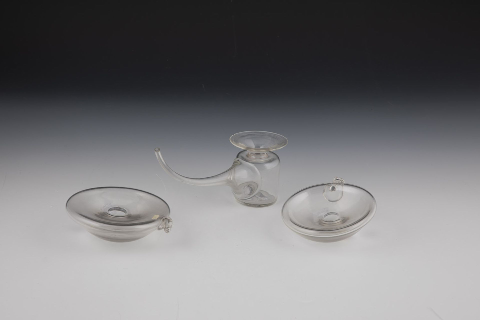 A breast pump and two breast glasses Germany, 19th century Colourless glass. Breast lenses D. 9.5
