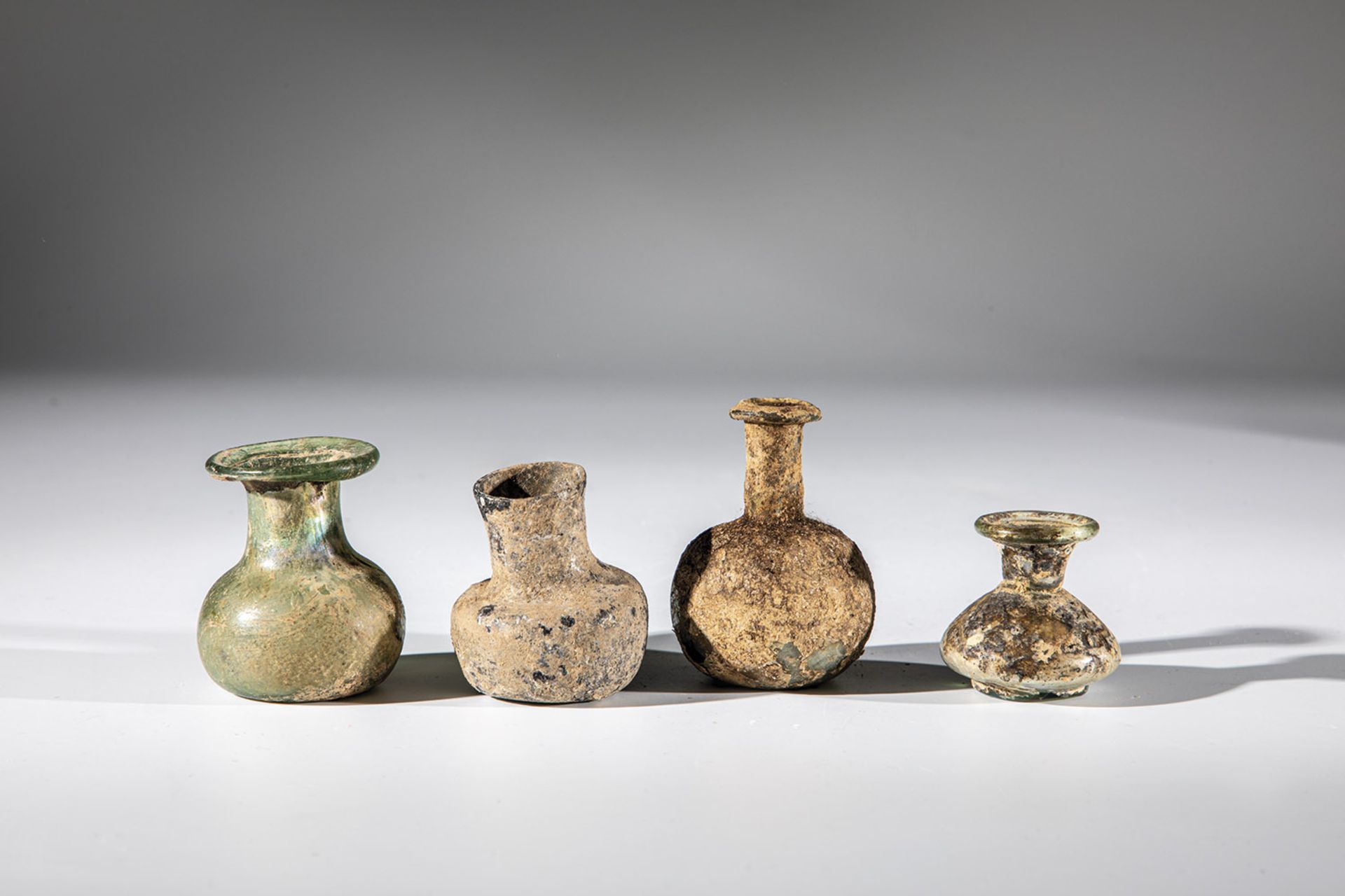 Four miniature vials Middle East, 1st-4th century AD Bottom finds. Greenish glass, partly with a