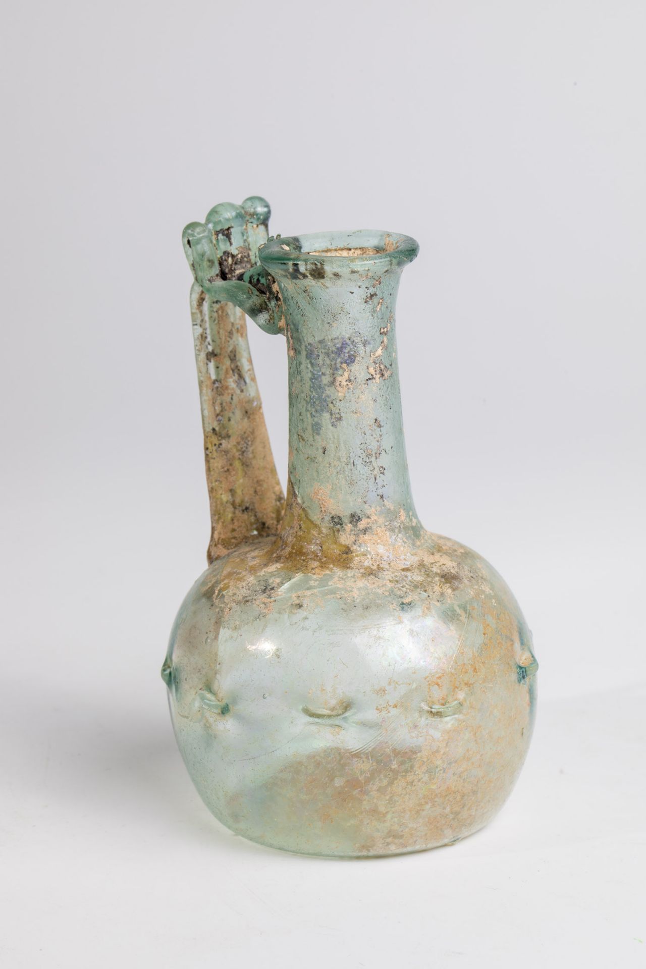 Handle bottle Eastern Mediterranean, 3rd-4th century A.D. Blue-green glass with a slightly raised