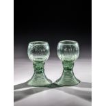 Pair of Romans Germany, 1st half of the 19th century Green glass with demolition. Woven foot.