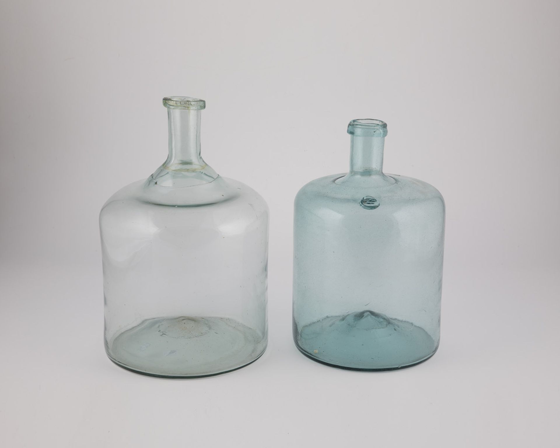 Two storage bottles of Austria, 19th century Light green glass with a raised bottom and tear-off. On