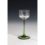 Stem glass Bohemia, circa 1910 Foot and shaft of green glass. Longitudinally optically blown