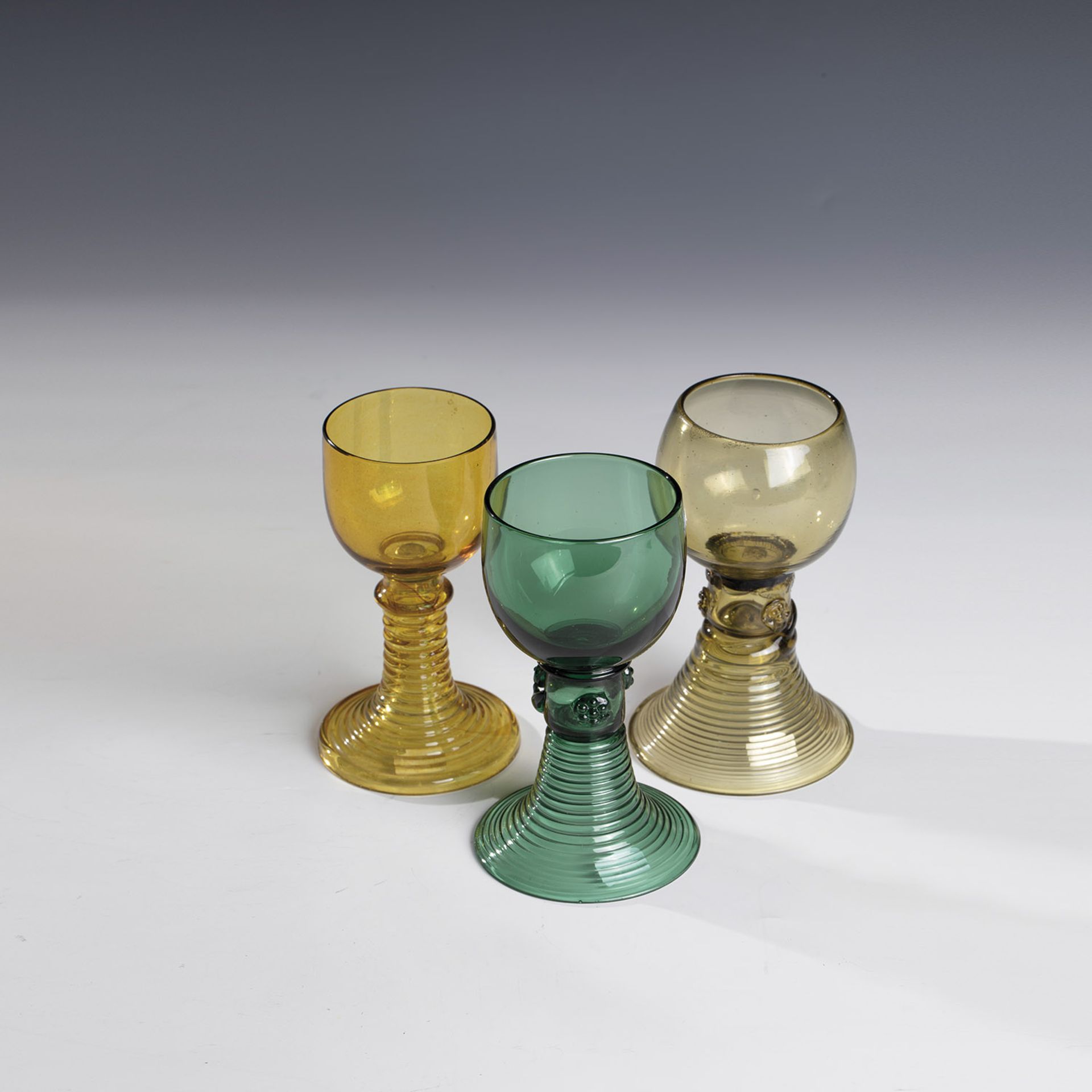 Three Romans 18th/19th century Green, amber and olive-coloured glass, partly with demolition. Two