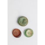 Three coins made of glass Eastern Mediterranean, 1st-4th century AD. Light green or violet glass,