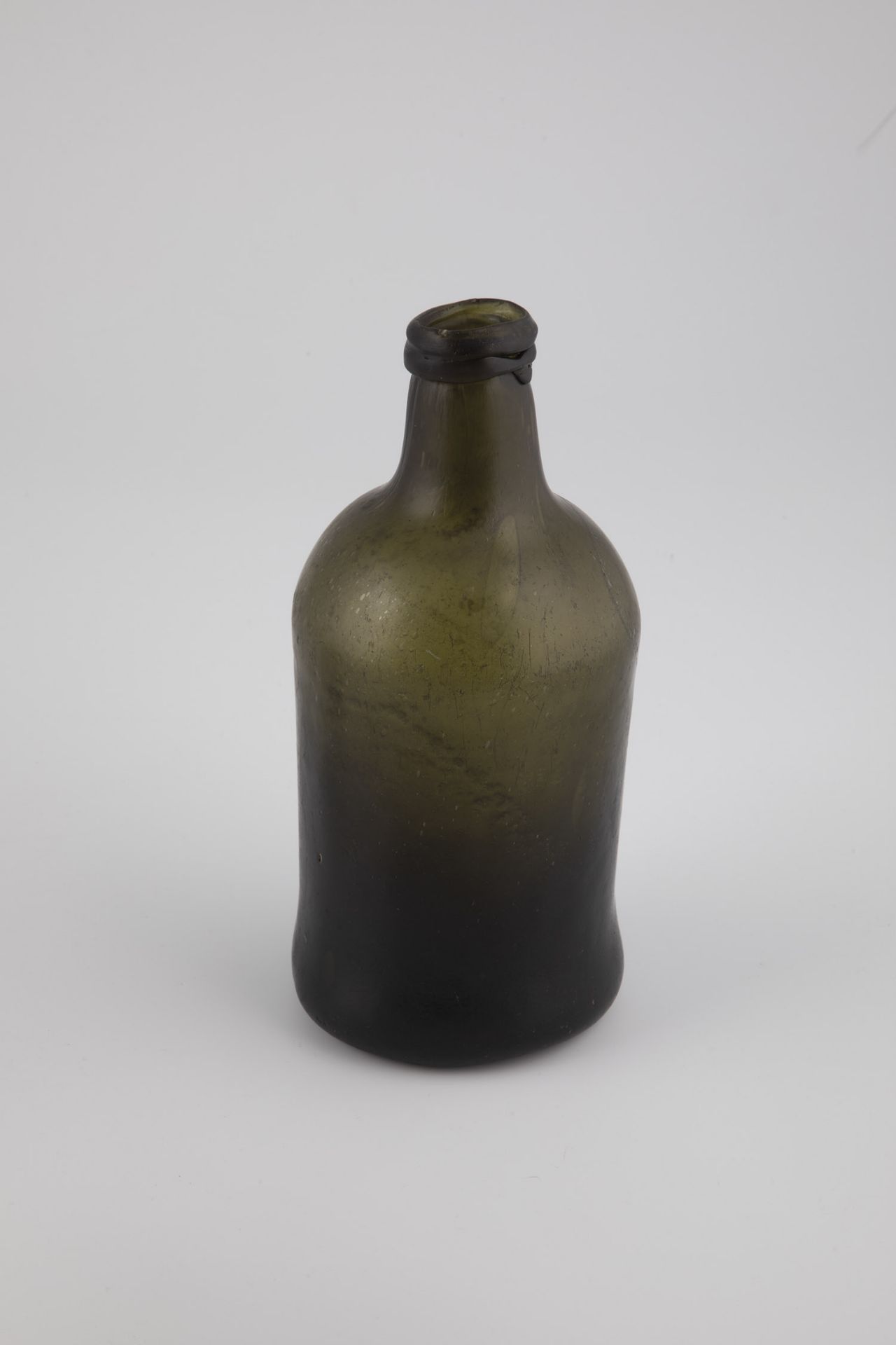 Bottle probably Northern Germany, 18th century Green, bubbled glass. Water find. High-pitched