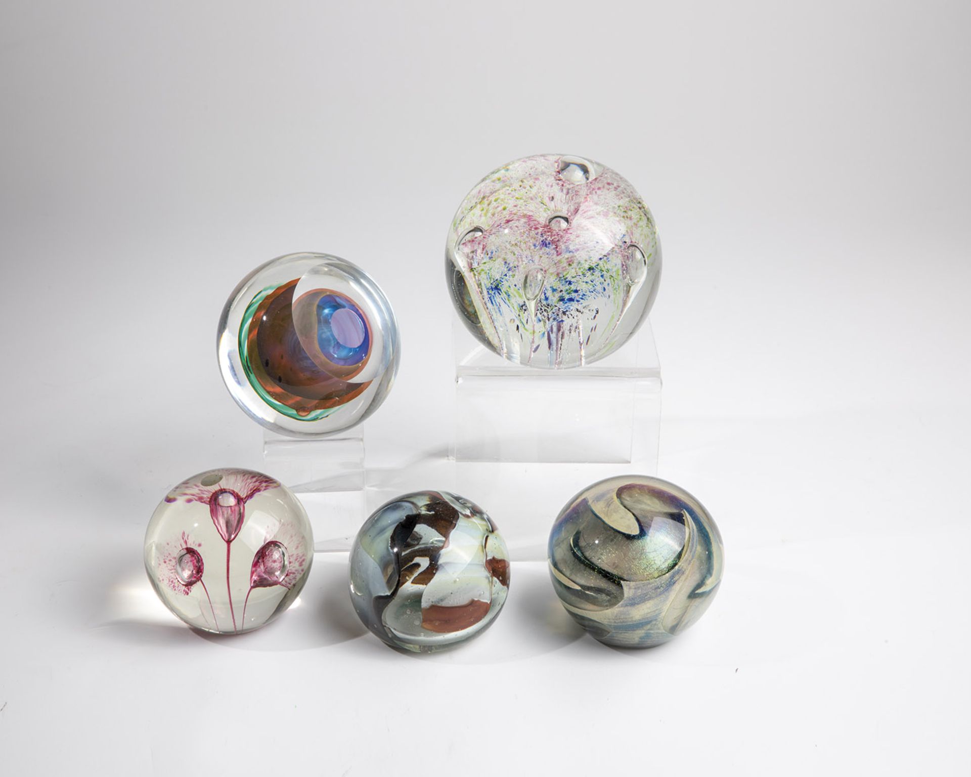 Five paperweights at the end of the 20th century: Five paperweights made of glass, one signed ''