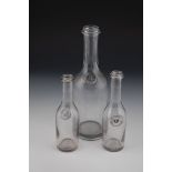 Three sealing bottles Probably Germany, 19th century Grey-tinted glass with embossed seal, glass