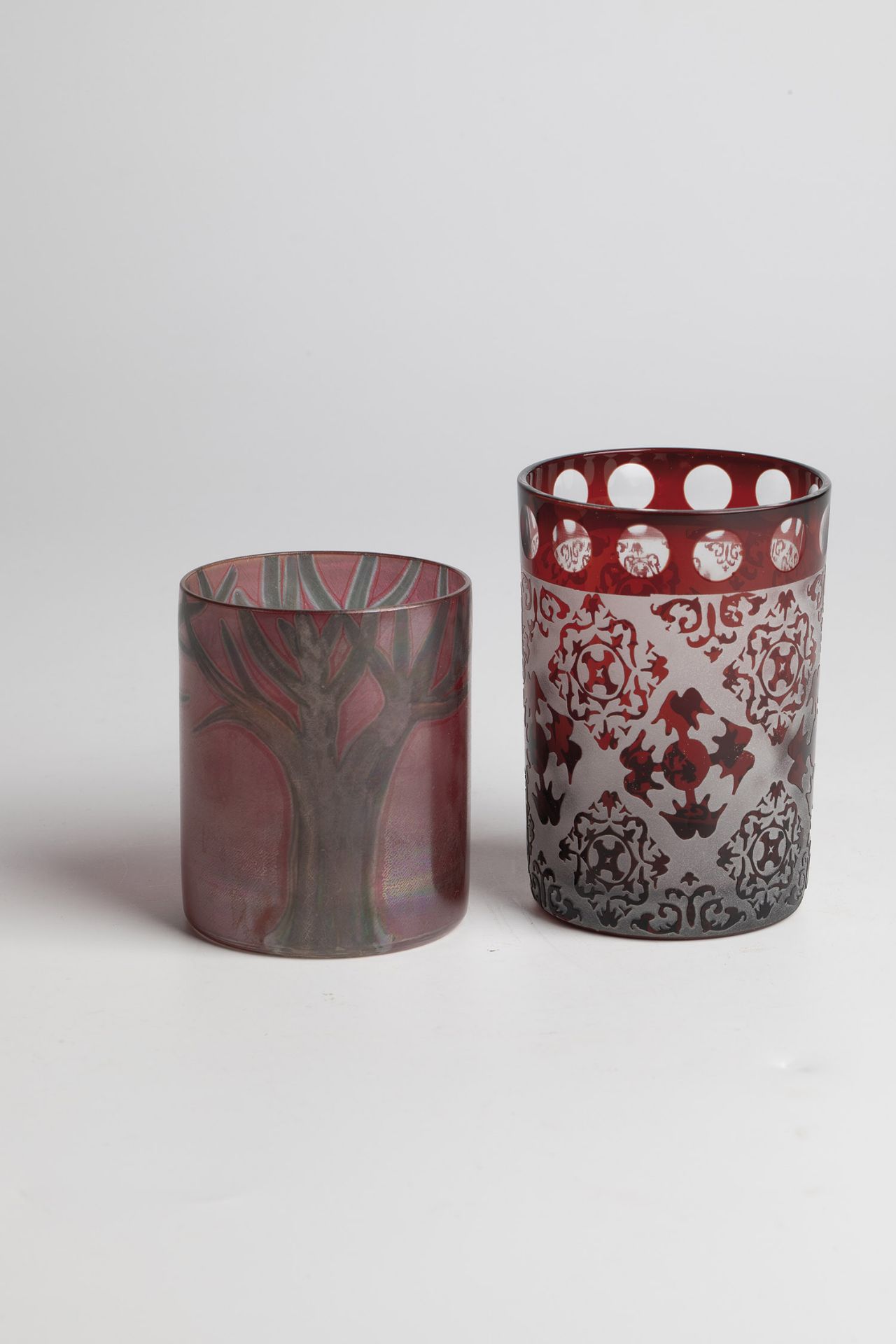 2 cups including Isgard Moje-Wohlgemuth, 1980 Colourless glass, ruby red overlay. Engraved lens