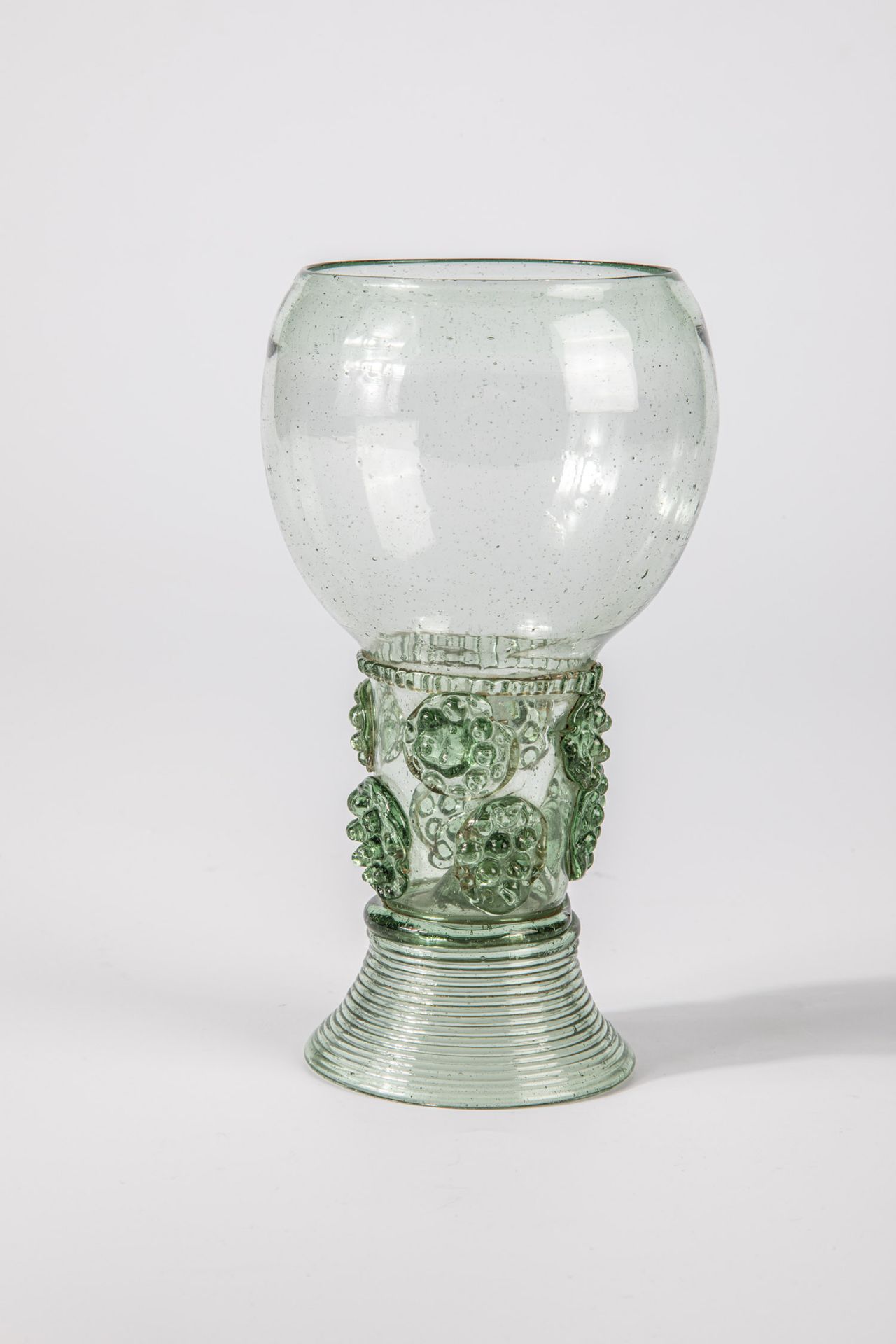 Roman German, 17th century Green glass with demolition. Trumpet-shaped, spun foot. Hollow shaft open