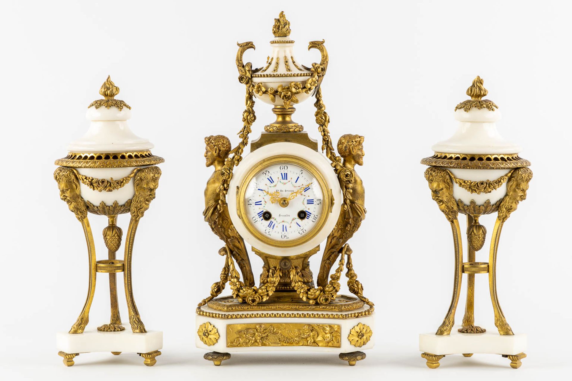 A three-piece mantle garniture clock and cassolettes, Carrara marble mounted with bronze, Louis XVI 