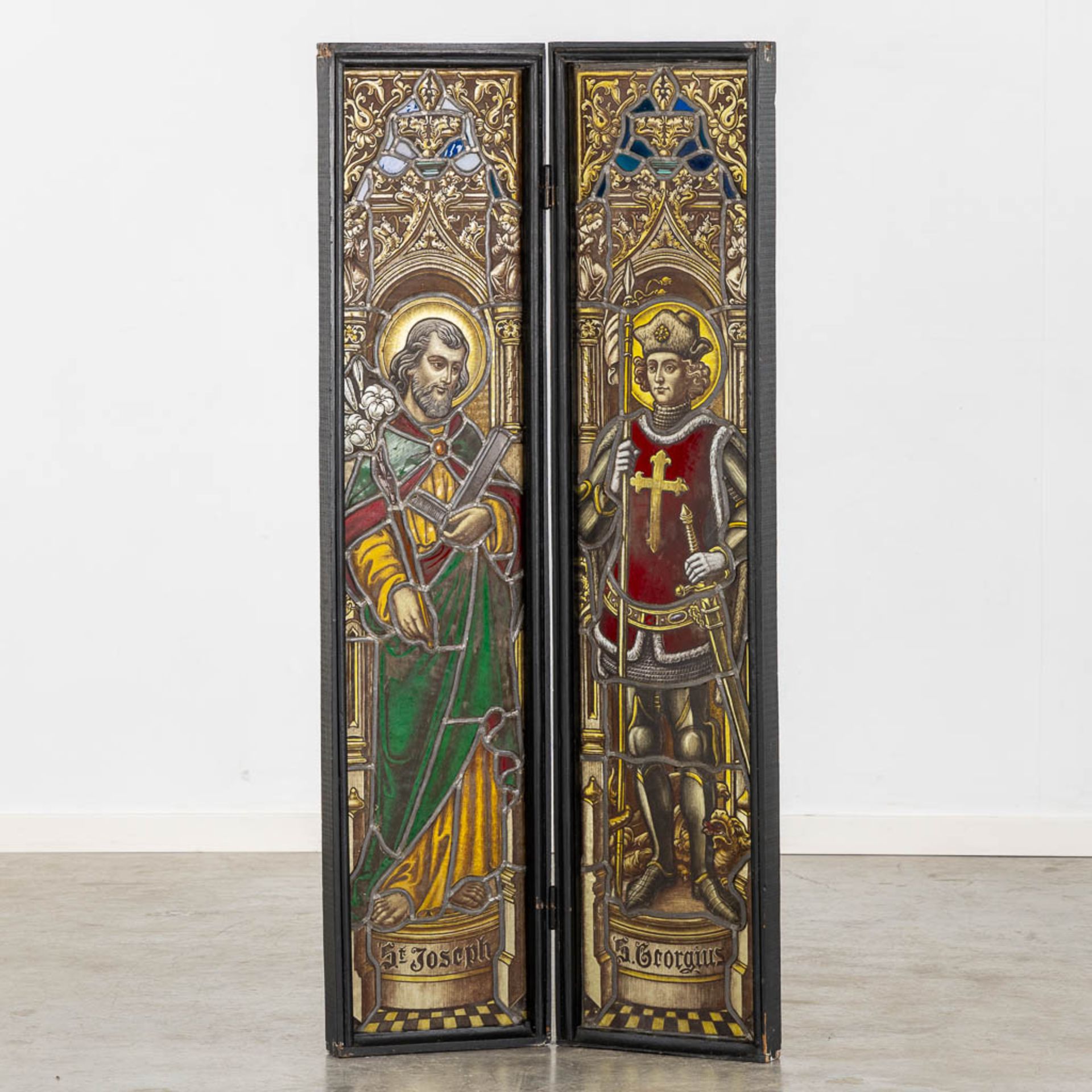 A pendant 'stained glass paintings', Saint Joseph and Gregory, in a wood frame. (W:136 x H:62 cm)