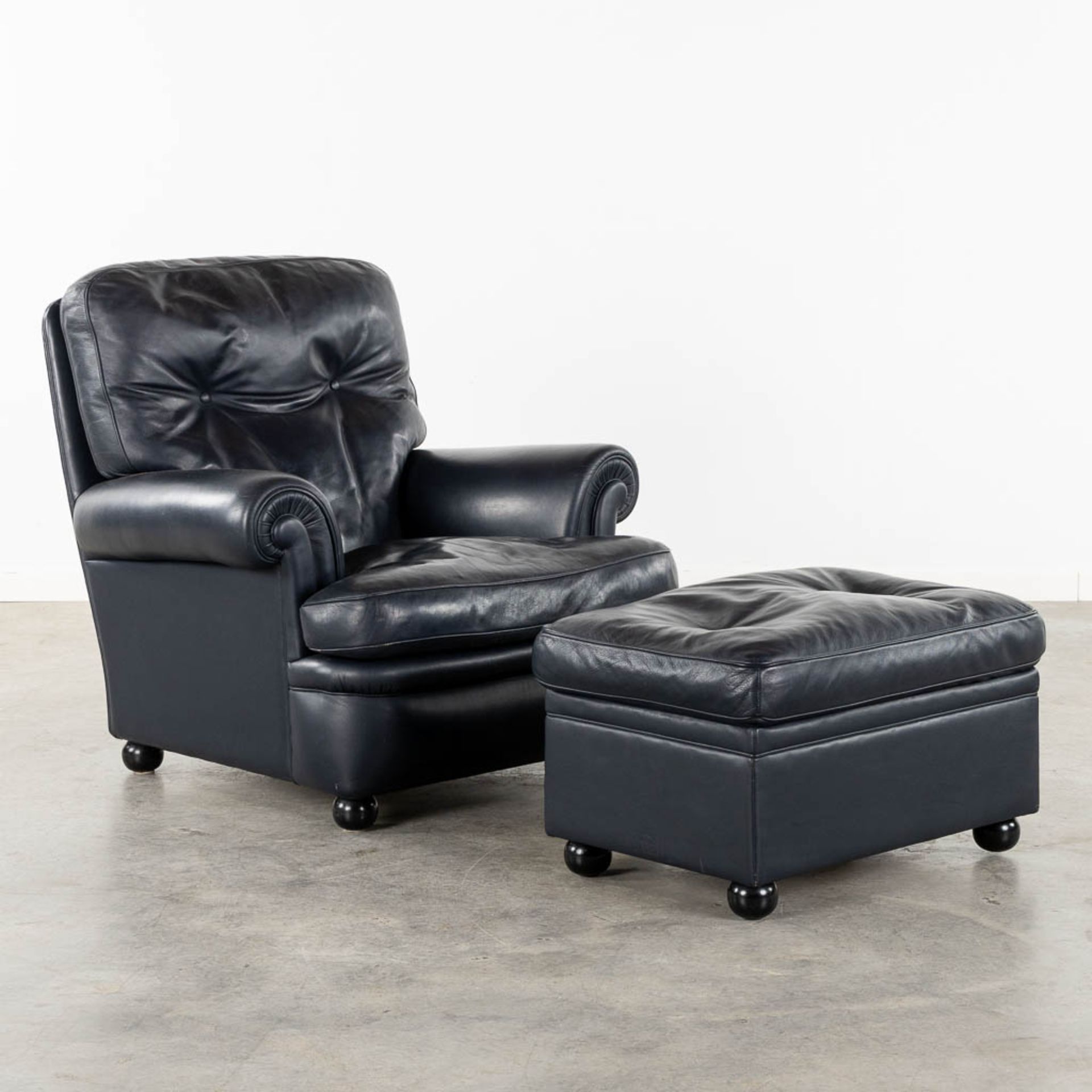 Poltrona Frau, a leather relaxing chair and matching ottoman. (L:90 x W:90 x H:88 cm)