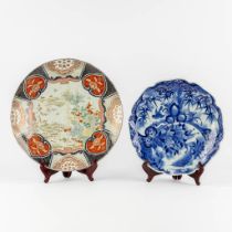 Two Japanese Imari and blue-white plates. 19th/20th C. (D:46 cm)
