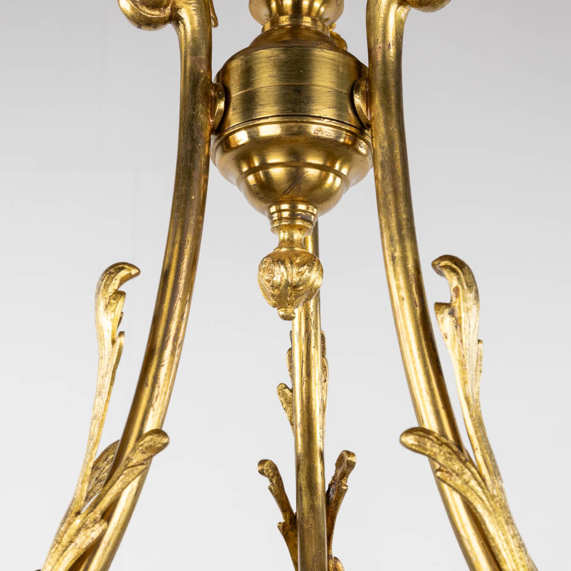 A chandelier, bronze with glass shades and a flambeau, decorated with Satyr figurines. (H:88 x D:54 - Image 6 of 13