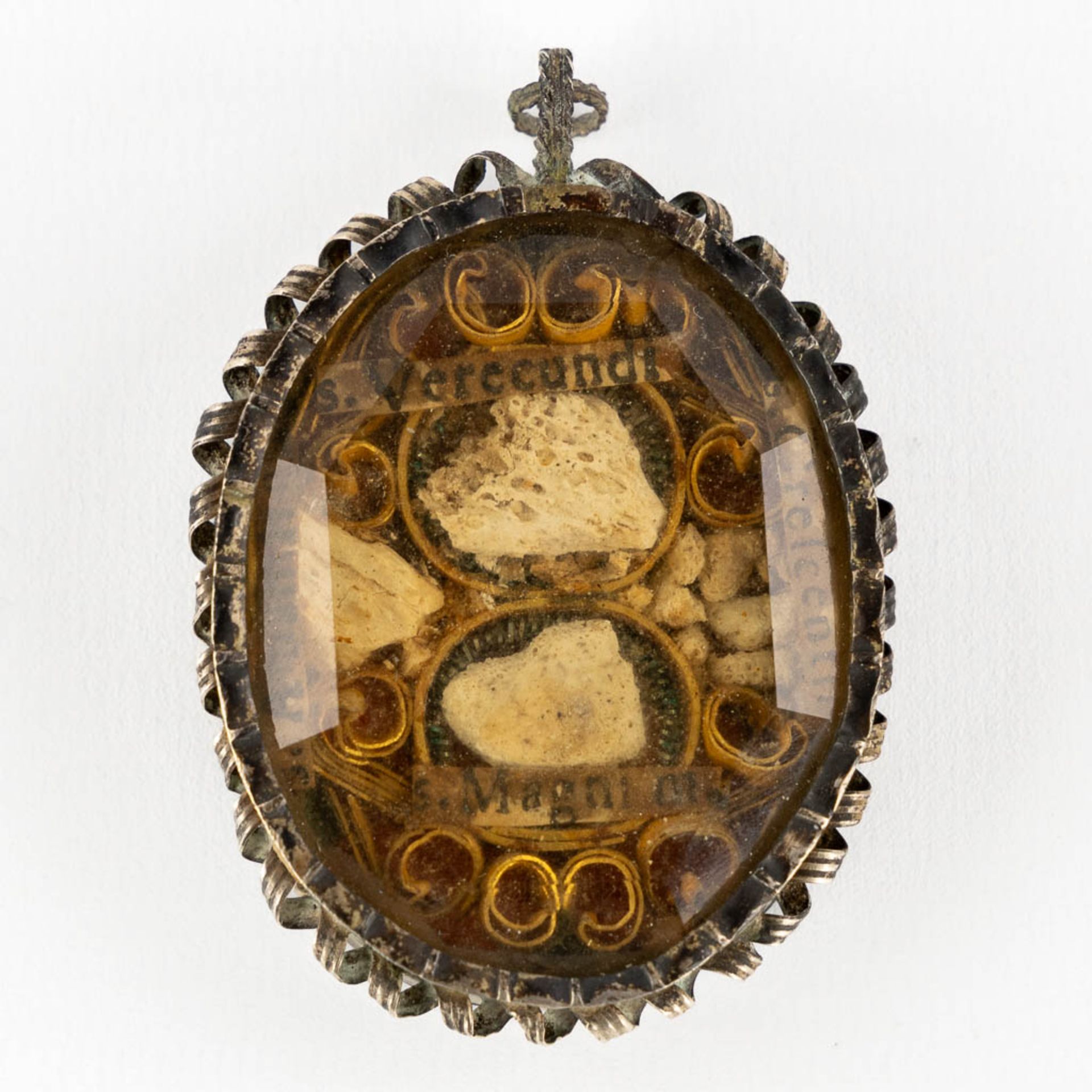 An antique sealed pendant reliquary, Ex Ossibus Verecundi, Magni, Amandi Martyr, Crecenti. Silver an