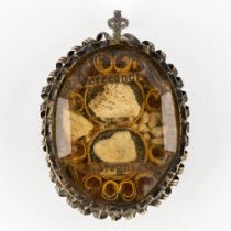 An antique sealed pendant reliquary, Ex Ossibus Verecundi, Magni, Amandi Martyr, Crecenti. Silver an