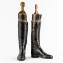 A pair of decorative leather boots with the matching moulds. (H:55 cm)