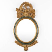 A mirror, gilt and sculptured wood in Hollywood Regency style. (W:41 x H:79 cm)