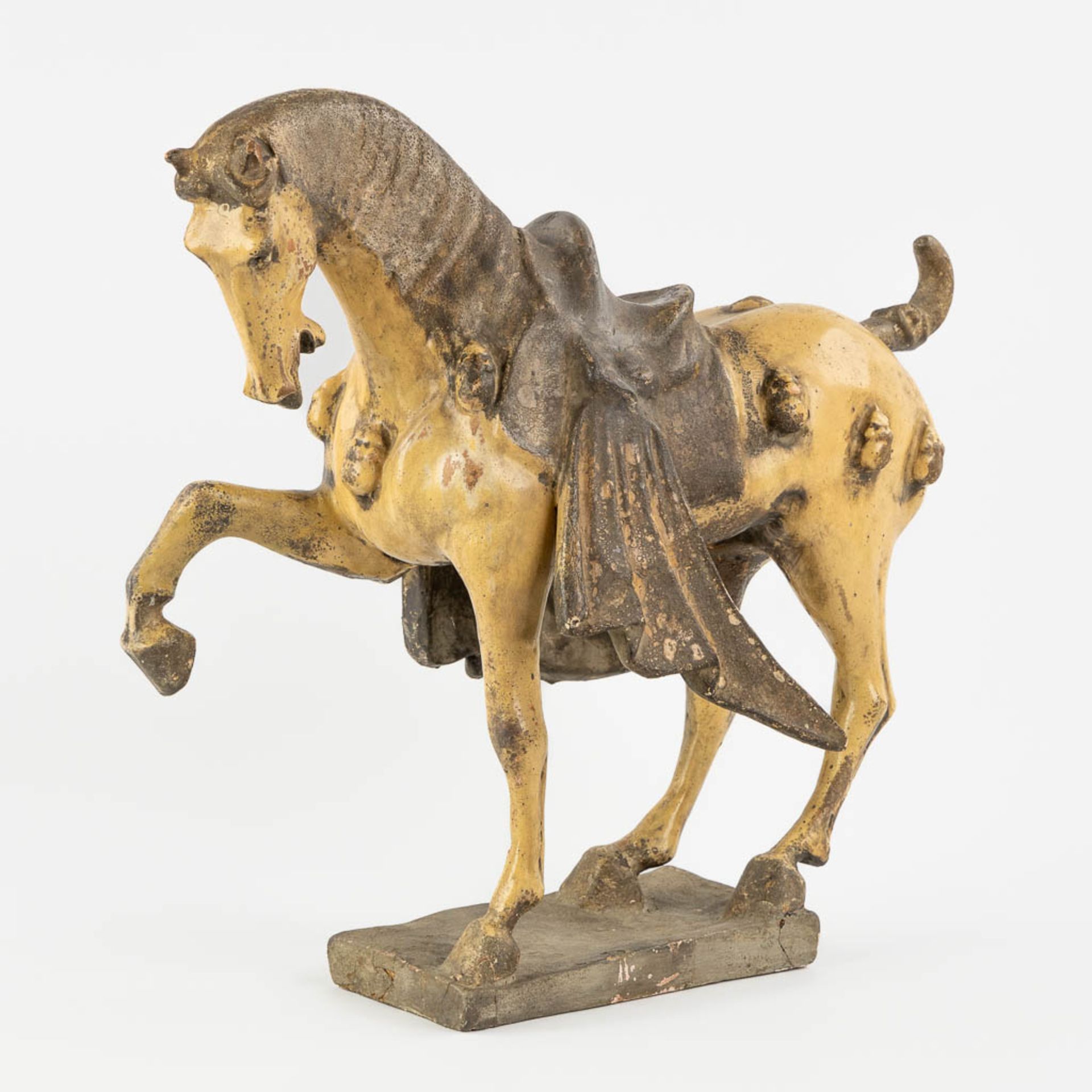 A terracotta figurine of a horse, in the style of Tang Dynasty. (L:20 x W:42 x H:42 cm)