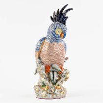 A large figurine of a parrot, polychrome porcelain. 20th C. (L:23 x W:18 x H:43,5 cm)