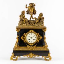 A mantle clock with dancing and musical Putti, Marble and bronze in Louis Philippe style. 19th C. (L