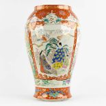 A large Japanese Kutani vase, decorated with fauna and flora. 19th C. (H:61 x D:38 cm)