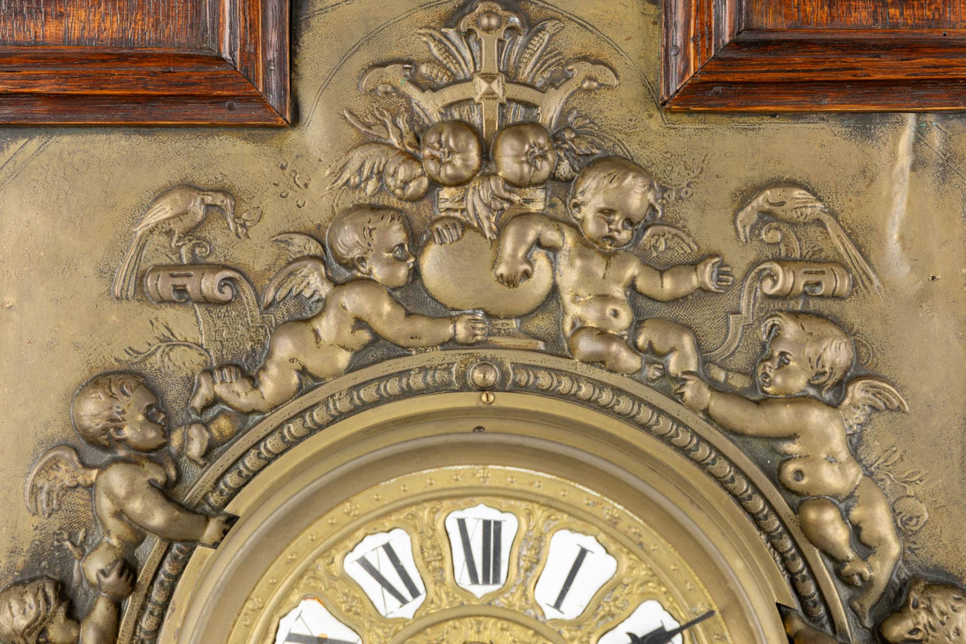 A wall-mounted clock, sculptured oak and repousse copper, decorated with putti and angels. 19th C. ( - Image 4 of 8