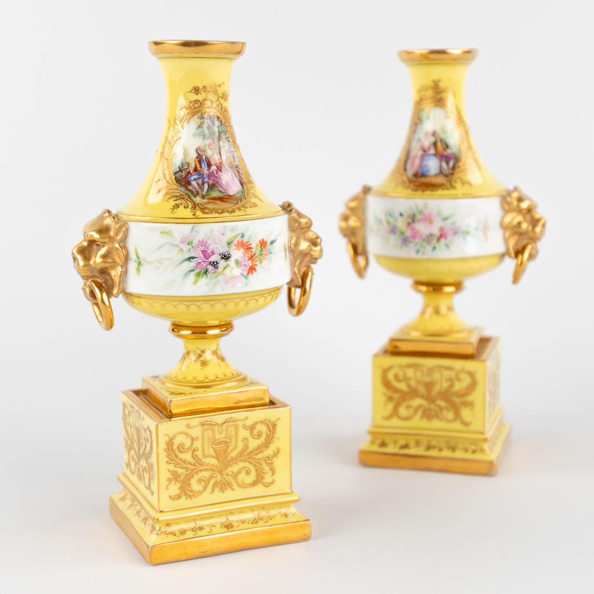 A pair of antique, hand-painted porcelain vases, yellow glaze and flower with lion's heads decor. (L