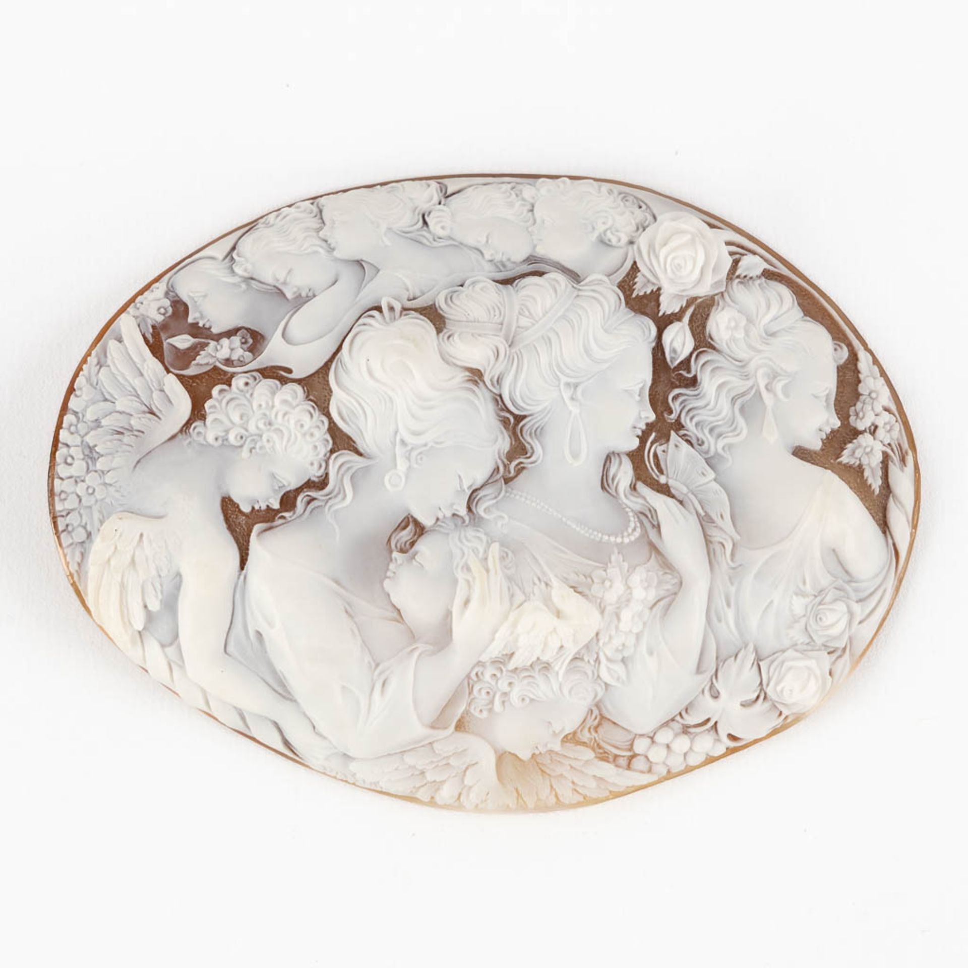 A Cameo, finely sculptured images of Three Graces, Angels and floral decor. (W: 9 x H:12,5 cm)