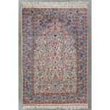 An Oriental hand-made carpet, wool and silk (L:185 x W:124 cm)
