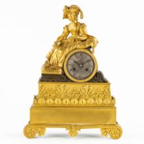 A mantle clock, gilt and patinated bronze, decorated with a lady. Empire, 19th C. (L:9,5 x W:27 x H: