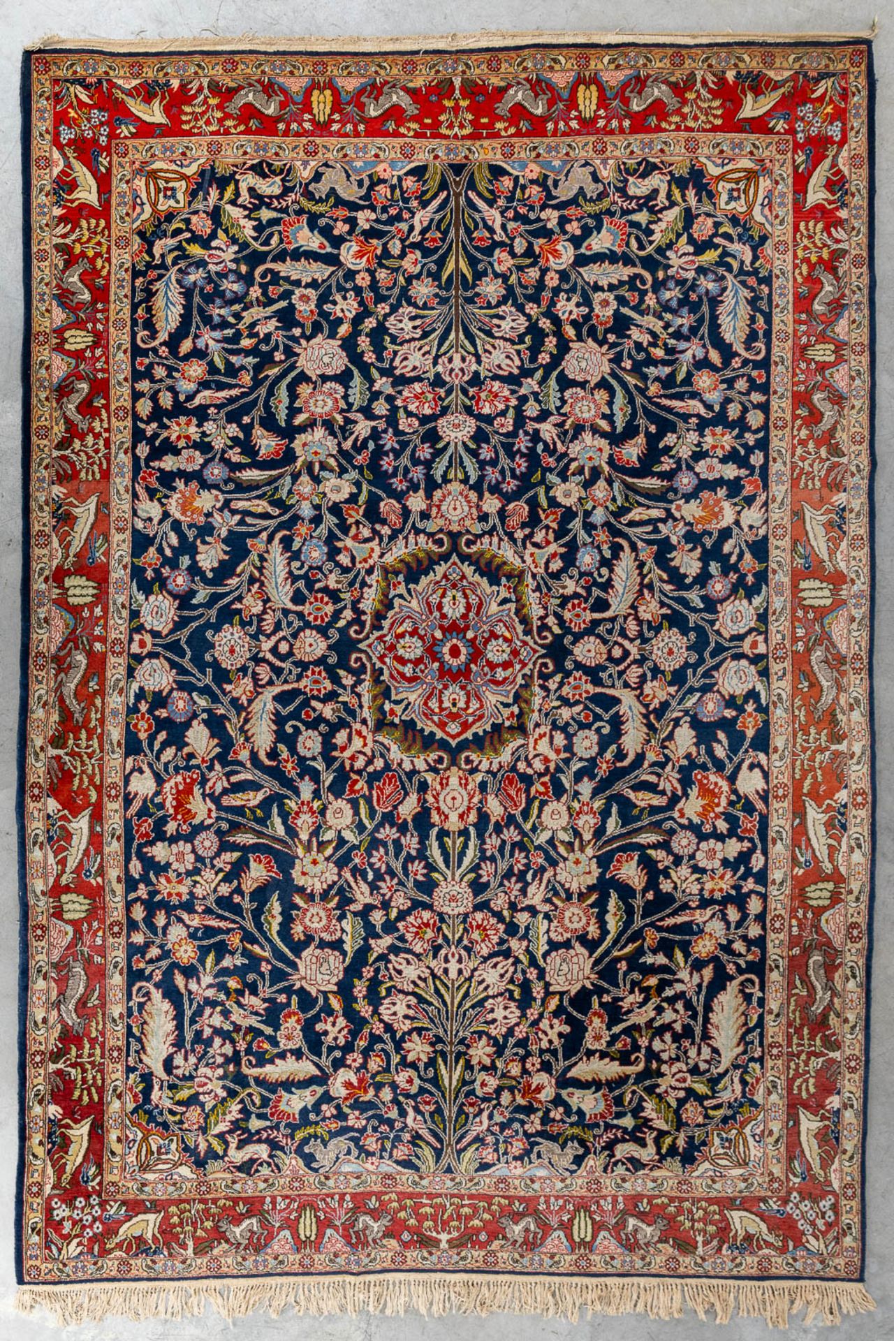 An Oriental, hand made carpet decorated with &quot;Fauna and Flora&quot;. (L: 320 x W: 223 cm)