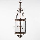 A large lantern, patinated metal and glass. Circa 1900. (H:144 x D:45 cm)