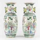 A pair of Chinese vases, decorated with figurines, fauna and flora. 19th/20th C. (H:57 x D:25 cm)