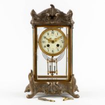 A small mantle clock, spelter in Louis XV style, Mercury Pendulum. Circa 1900. (L:17 x W:20 x H:36 c