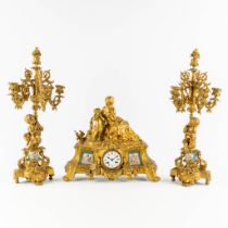 A three-piece mantle garniture clock and candelabra, gilt bronze in Louis XV style. 19th C. (L:16 x