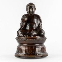 A Buddha seated on a lotus flower, patinated bronze. (H:50 x D:30 cm)