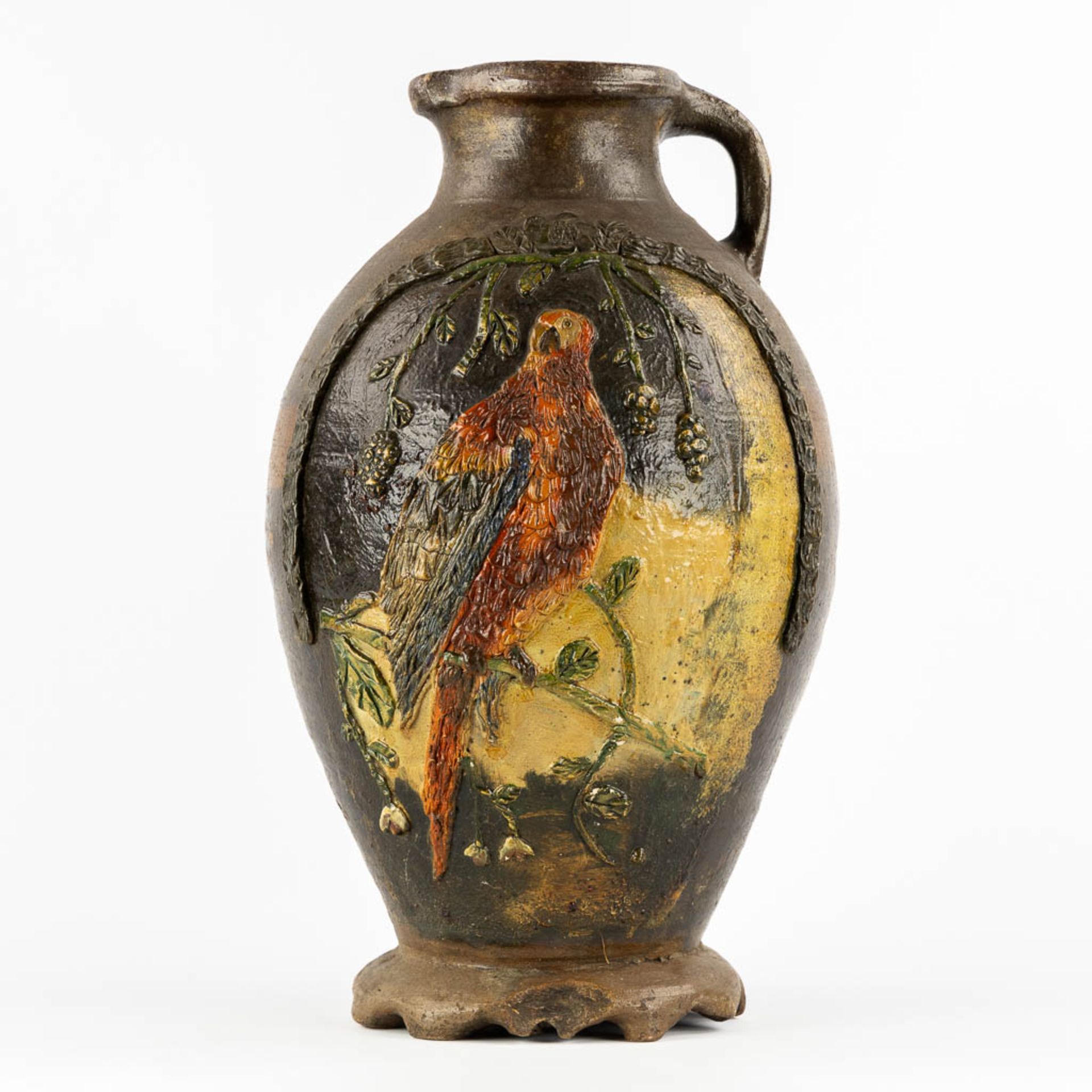 An antique pitcher with an Ara decor, Langerweghe/Raeren, Germany. Glazed stoneware. (H:46 x D:27 cm