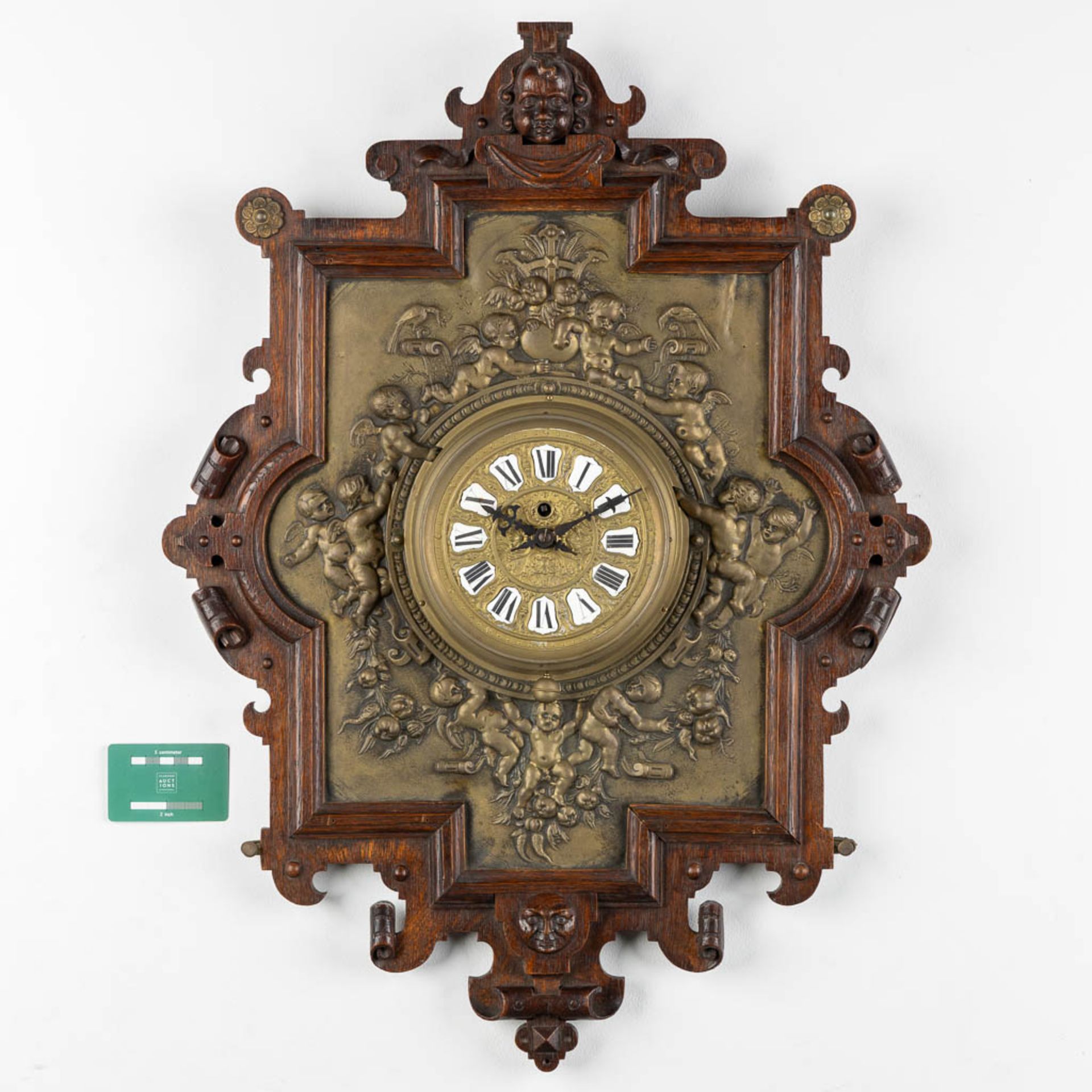 A wall-mounted clock, sculptured oak and repousse copper, decorated with putti and angels. 19th C. ( - Image 2 of 8