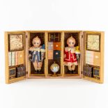 Hertel Schwab, Two 'Kewpie' dolls in the original box. Glass Eyes, Germany. (L:7,5 x W:59 x H:26 cm)