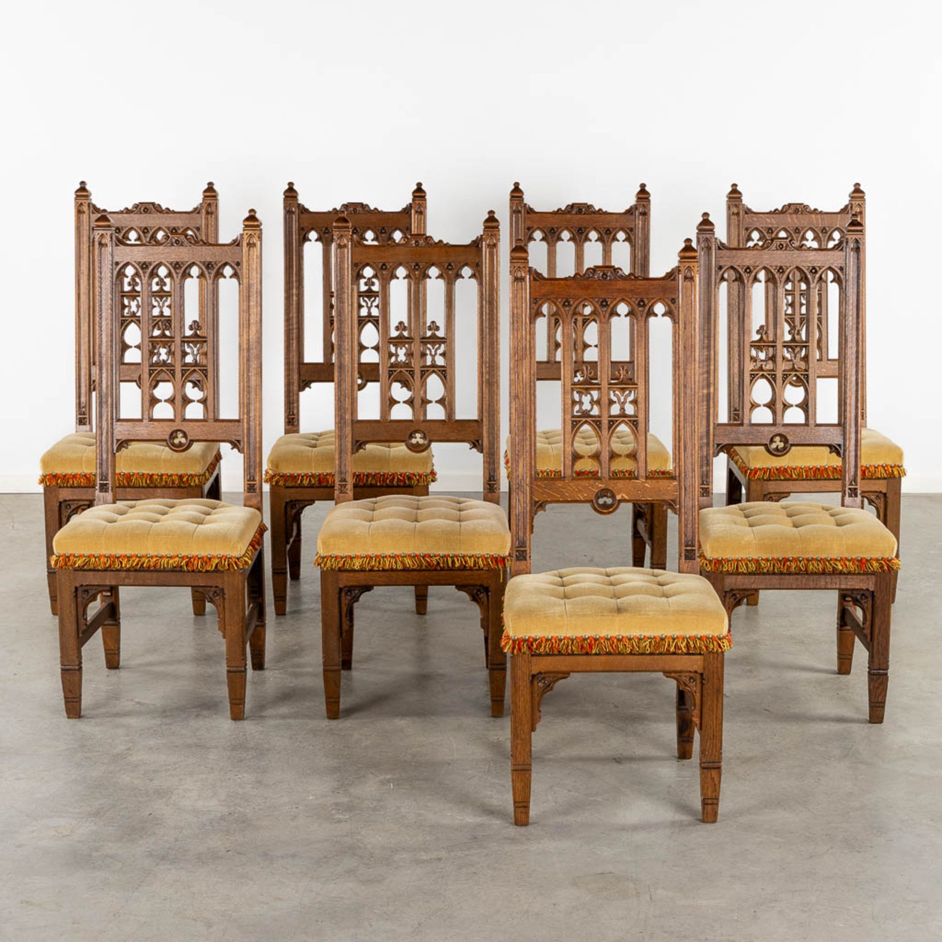 8 Gothic Revival style chairs, sculptured wood. Circa 1900. (L:54 x W:48 x H:123 cm)