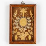 A small reliquary frame with 10 relics and an Agnus Dei. Our Lady, Clara, Colette, Anthony and more.
