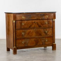 A four-drawer commode, wood veneer mounted with gilt bronze and a black marble top. Empire style, 19