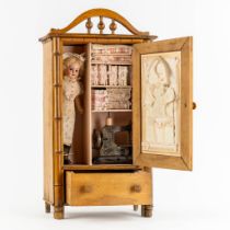 Armand Marseille, a doll with attributes stored in a faux bamboo wardrobe. Circa 1900. (L:16 x W:35