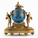 A mantle clock, blue lacquered brass, decorated with rams and children. France, 19th C. (L:15 x W:30