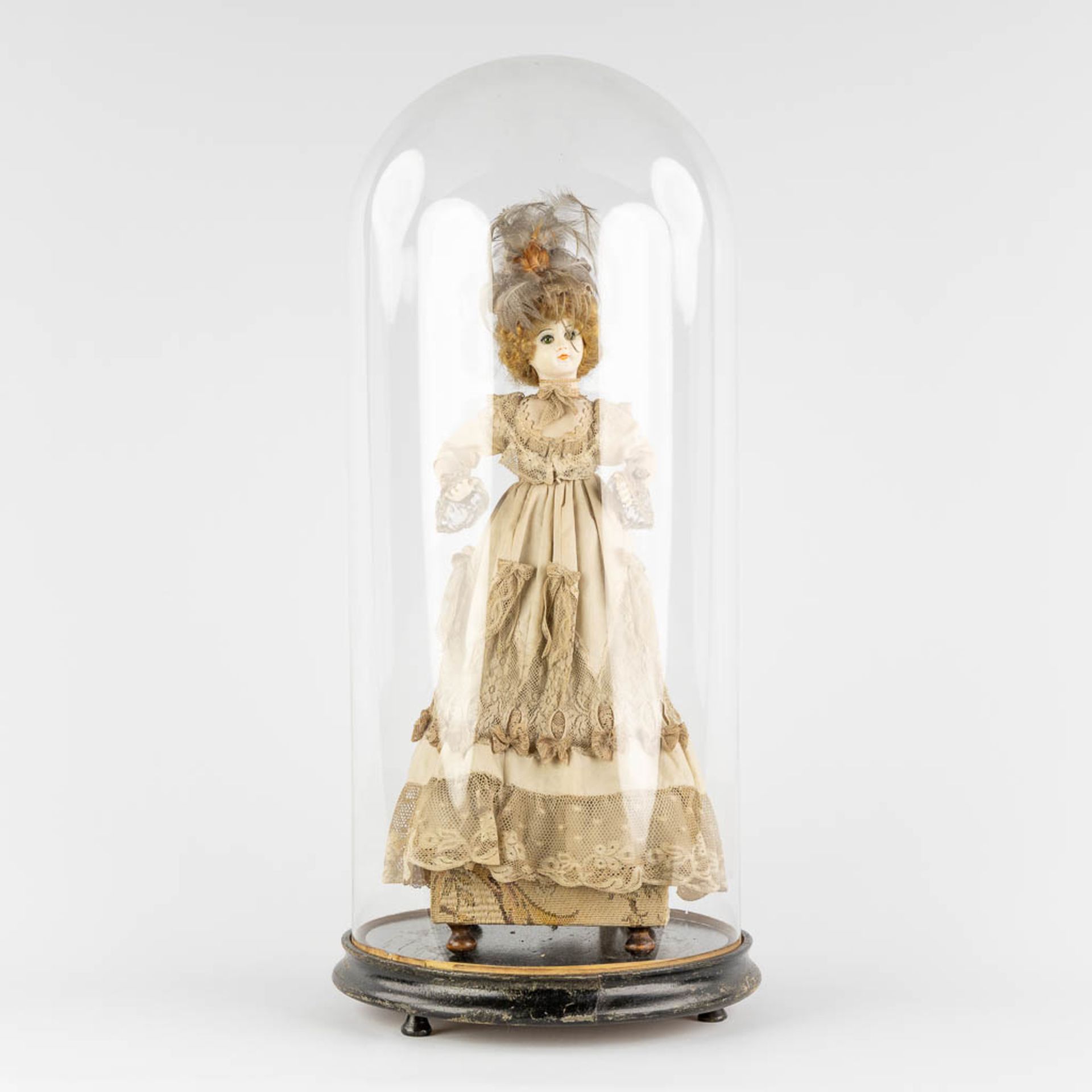 An antique 'Automata', in lace dressed doll with a music box. Under a glass dome, Circa 1920. (H:48