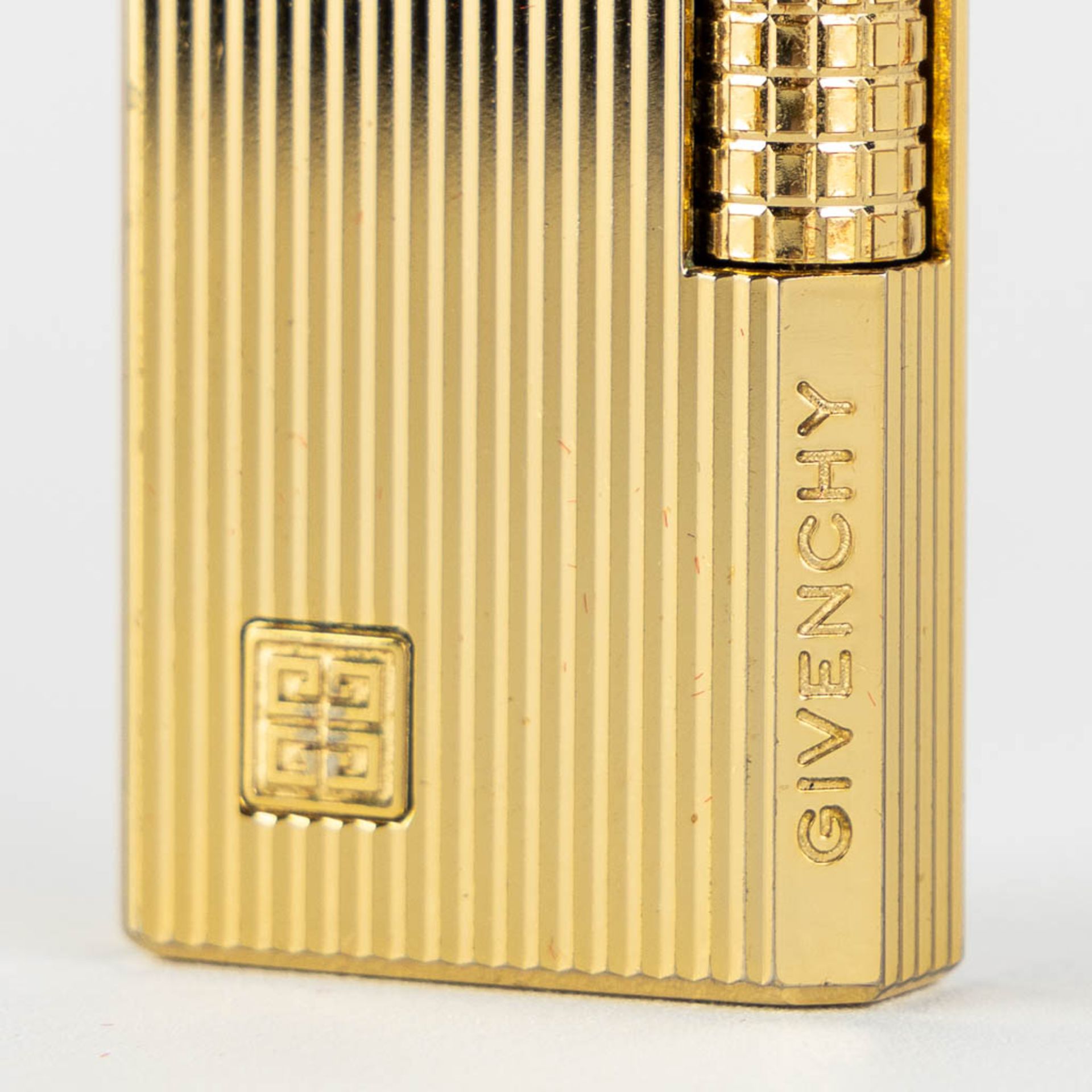 ST. Dupont, Three gold and silver plated lighters, added a Givency lighter. (L:1 x W:3,5 x H:6 cm) - Image 13 of 14